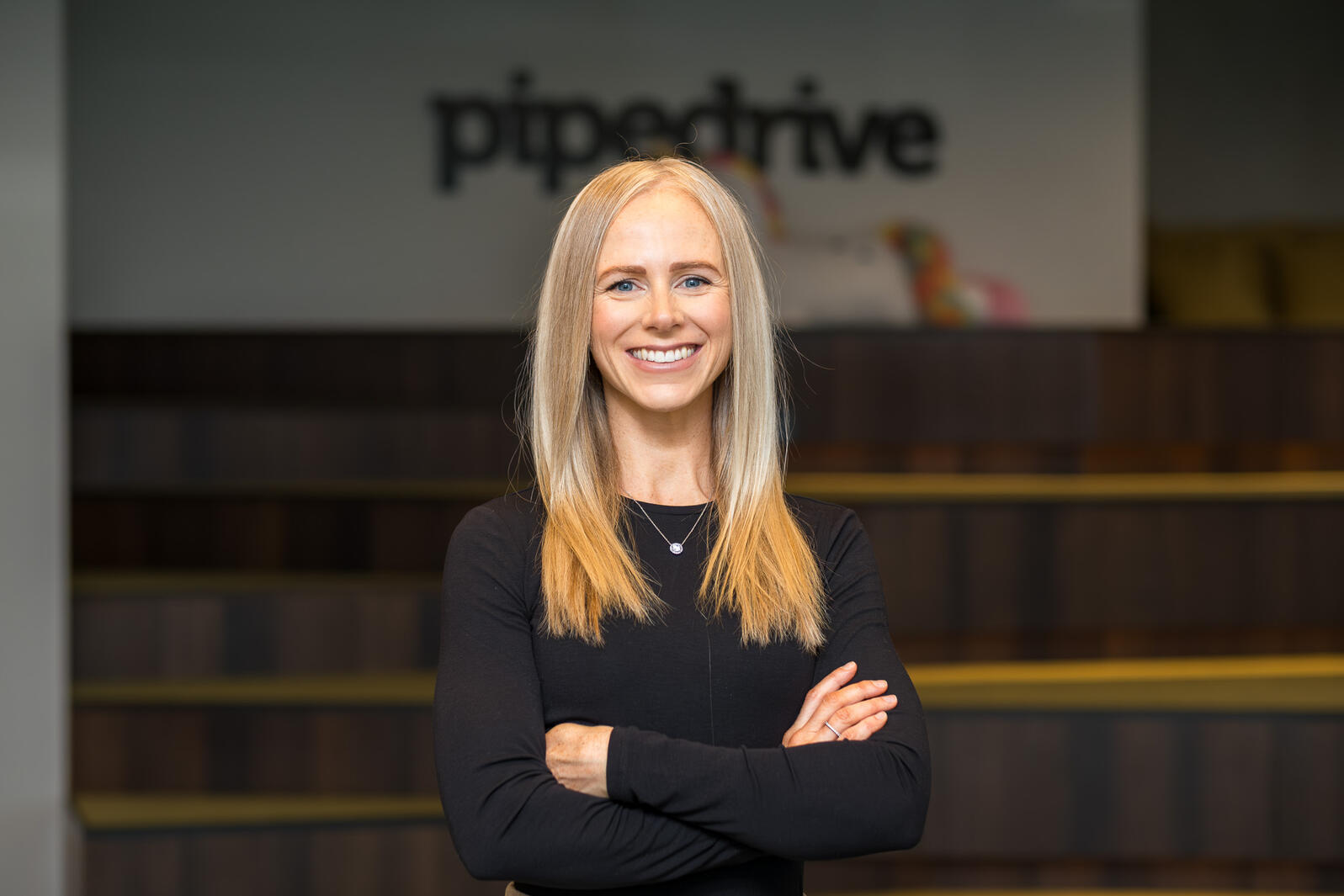 Pipedrive Naeratav Pipedrive töötaja ametiportreel kontorikeskkonnas